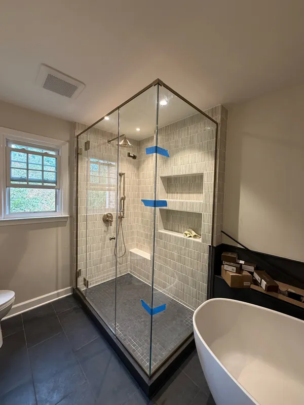 Custom corner shower door installation with brushed nickel hardware