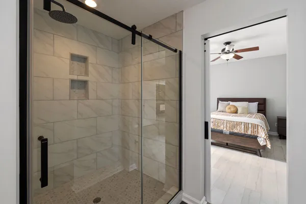 Sliding glass shower door with matte black rail